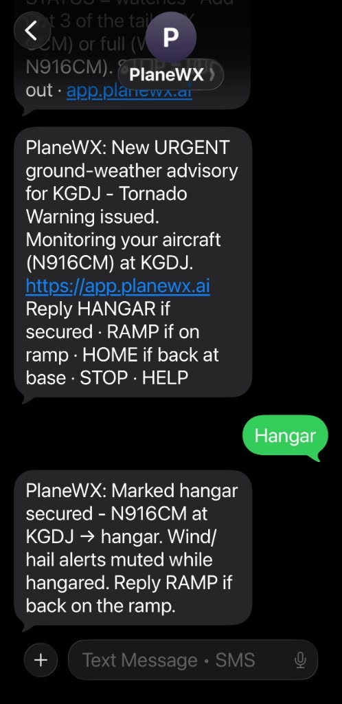 iPhone Messages thread: PlaneWX sends an Urgent tornado warning for N916CM at KGDJ; the pilot replies Hangar; PlaneWX confirms the aircraft is hangar-secured and wind/hail alerts are muted